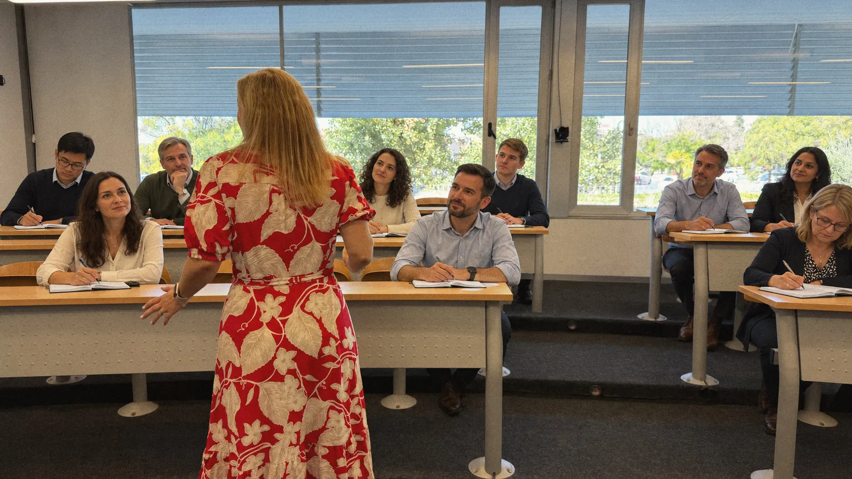 Kirsten leading a session, the group listening and taking notes